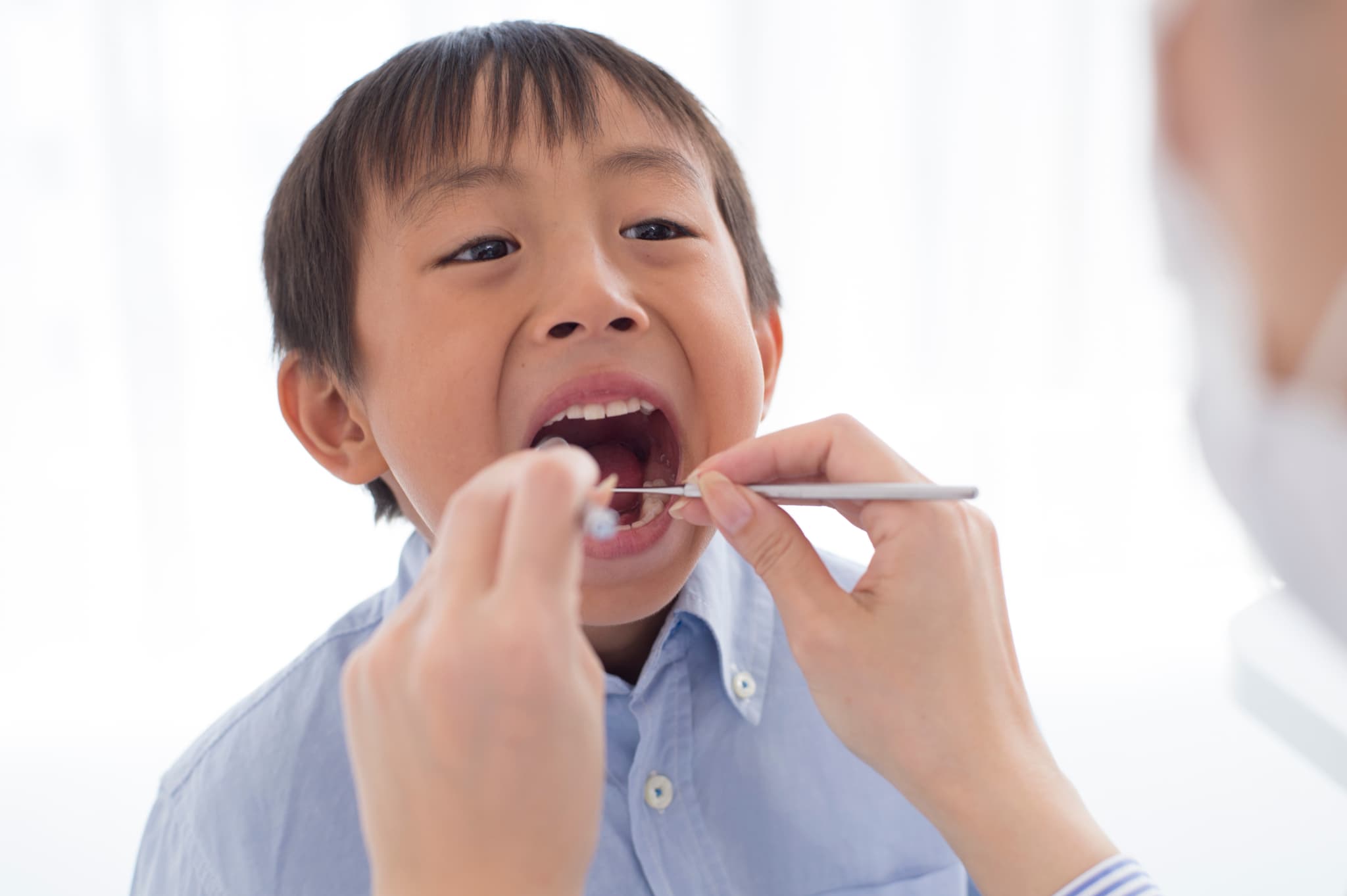 口腔内のチェックを受ける男の子